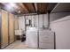 Efficient basement laundry room with sink and machines at 6028 Thornwood Ct, Indianapolis, IN 46250