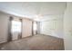 Spacious main bedroom with large windows, neutral carpet, and a ceiling fan at 6028 Thornwood Ct, Indianapolis, IN 46250