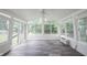 Bright sunroom featuring hardwood floors, a ceiling fan, and multiple windows offering backyard views at 6028 Thornwood Ct, Indianapolis, IN 46250