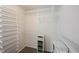Walk-in closet with open shelving, storage baskets, and shoe racks at 6028 Thornwood Ct, Indianapolis, IN 46250