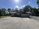 This is a backyard with a concrete patio, chimney, basketball hoop and white fence at 6238 E Southport Rd, Indianapolis, IN 46237