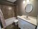 Bathroom featuring shower over tub and vanity with decorative mirror at 6238 E Southport Rd, Indianapolis, IN 46237