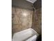 Bathroom with a tiled bathtub and shower combo, complete with chrome fixtures at 6238 E Southport Rd, Indianapolis, IN 46237