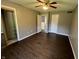 Bedroom with dark wood floors, a ceiling fan, and closet at 6238 E Southport Rd, Indianapolis, IN 46237