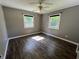 Bedroom with neutral paint, two windows and luxury vinyl flooring at 6238 E Southport Rd, Indianapolis, IN 46237