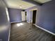 Bedroom with light wood floors and a double closet at 6238 E Southport Rd, Indianapolis, IN 46237