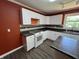 Modern kitchen features white cabinets, stainless steel appliances, and modern flooring and backsplash at 6238 E Southport Rd, Indianapolis, IN 46237