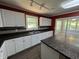 Modern kitchen features white cabinetry, dark countertops, and an island, perfect for cooking at 6238 E Southport Rd, Indianapolis, IN 46237