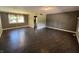 Spacious living room featuring modern flooring, neutral wall colors, and large windows at 6238 E Southport Rd, Indianapolis, IN 46237