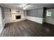 Spacious living room with luxury vinyl flooring, fireplace with built-ins, and neutral paint at 6238 E Southport Rd, Indianapolis, IN 46237