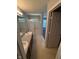 Bathroom featuring double sink vanity and shower with glass doors at 6504 Potomac Square Ln, Indianapolis, IN 46268