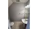 Compact bathroom featuring a pedestal sink, tiled flooring, and modern fixtures for a clean and efficient space at 6504 Potomac Square Ln, Indianapolis, IN 46268