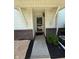Charming entryway featuring a glass storm door, brick accents, and well-maintained landscaping for a welcoming first impression at 6504 Potomac Square Ln, Indianapolis, IN 46268