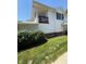 Two-story home featuring white siding, a small wooden porch, and manicured greenery, blending charm with curb appeal at 6504 Potomac Square Ln, Indianapolis, IN 46268