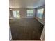 Spacious living room featuring plush carpeting, neutral walls, and sliding glass doors to enhance natural light and space at 6504 Potomac Square Ln, Indianapolis, IN 46268