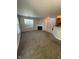 Spacious living room featuring a modern fireplace, neutral paint, and plush carpeting for a cozy atmosphere at 6504 Potomac Square Ln, Indianapolis, IN 46268