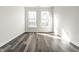 Open bedroom featuring wood-look flooring, white trim and lots of natural light at 6592 Reserve Dr, Indianapolis, IN 46220