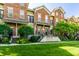 Attractive brick townhouse with a well-manicured lawn and lush landscaping at 6592 Reserve Dr, Indianapolis, IN 46220