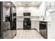 Bright kitchen featuring white cabinets and stainless steel hardware and black appliances at 6592 Reserve Dr, Indianapolis, IN 46220