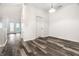 Open living space with wood-look floors, a doorway, and natural light at 6592 Reserve Dr, Indianapolis, IN 46220