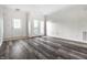 Bright living room with wood-look floors, white walls, and access to the outside at 6592 Reserve Dr, Indianapolis, IN 46220