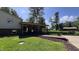 Exterior view of a home with a covered back porch and landscaped yard with a path at 6602 S 400 W, Columbus, IN 47201