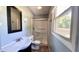 Bright bathroom featuring a vanity sink, toilet, and enclosed shower with a window at 6602 S 400 W, Columbus, IN 47201