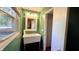 Bathroom featuring a utility sink, and a window with green painted walls at 6602 S 400 W, Columbus, IN 47201