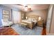 Inviting bedroom with a wooden bed frame, soft lighting, and a serene ambiance at 6602 S 400 W, Columbus, IN 47201