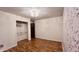 Bedroom boasts hardwood floors, floral wallpaper, walk in closet, and a decorative light fixture at 6602 S 400 W, Columbus, IN 47201