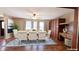 A spacious dining room featuring a wooden table, comfortable upholstered chairs, and hardwood floors at 6602 S 400 W, Columbus, IN 47201