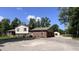 Side view of a two-story brick and vinyl home featuring an attached garage and ample parking space at 6602 S 400 W, Columbus, IN 47201