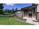 Exterior shot of a well-maintained brick home, highlighted by a manicured lawn and colorful flowerbeds at 6602 S 400 W, Columbus, IN 47201