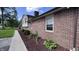 Close up on a brick home's exterior, showcasing the meticulously maintained landscaping at 6602 S 400 W, Columbus, IN 47201