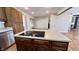Kitchen island cooktop complements sleek stainless steel appliances and wood flooring creating culinary space at 6602 S 400 W, Columbus, IN 47201