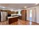 Open kitchen featuring stainless steel appliances, island cooktop, wood floors and ample cabinet space at 6602 S 400 W, Columbus, IN 47201