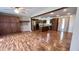 Spacious living room with wooden floors, cabinets, and modern stainless steel kitchen appliances at 6602 S 400 W, Columbus, IN 47201