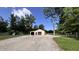 Outbuilding with two car garage doors near trees and a playground at 6602 S 400 W, Columbus, IN 47201