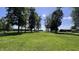 Expansive green lawn area with mature trees and open space for various activities at 6602 S 400 W, Columbus, IN 47201