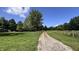 Scenic drive leading to a private property surrounded by lush greenery and open spaces at 6602 S 400 W, Columbus, IN 47201
