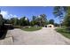 Wide shot of gravel driveway with a large yard and outbuilding at 6602 S 400 W, Columbus, IN 47201