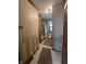 This cozy bathroom includes a tub with a shower and a vanity with a sink and a dark wood cabinet at 6895 N County Road 625 E, Brownsburg, IN 46112