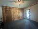 A bedroom showcases a wood panel accent wall, a ceiling fan, and natural light from the window at 6895 N County Road 625 E, Brownsburg, IN 46112