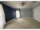 An inviting bedroom painted in two tones with a ceiling fan and a closet space at 6895 N County Road 625 E, Brownsburg, IN 46112