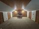 An ample bonus room boasts wood paneling, carpet floors, and two closets with paneled doors at 6895 N County Road 625 E, Brownsburg, IN 46112