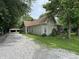 A charming house shows its exterior with a gravel driveway, a quaint porch, and a well-maintained lawn at 6895 N County Road 625 E, Brownsburg, IN 46112