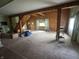 A spacious living room with wood paneling, natural light, and a staircase leading to another level at 6895 N County Road 625 E, Brownsburg, IN 46112