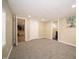 Basement featuring light walls, plush gray carpeting, an open floorplan, and an open doorway at 71 E Cove Ct, Cicero, IN 46034