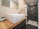 Bathroom featuring modern vanity, wood countertop, stylish squared sink, and tiled walk-in shower at 71 E Cove Ct, Cicero, IN 46034