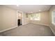 Bedroom featuring light walls, plush gray carpeting, ensuite bathroom, and natural light from multiple windows at 71 E Cove Ct, Cicero, IN 46034